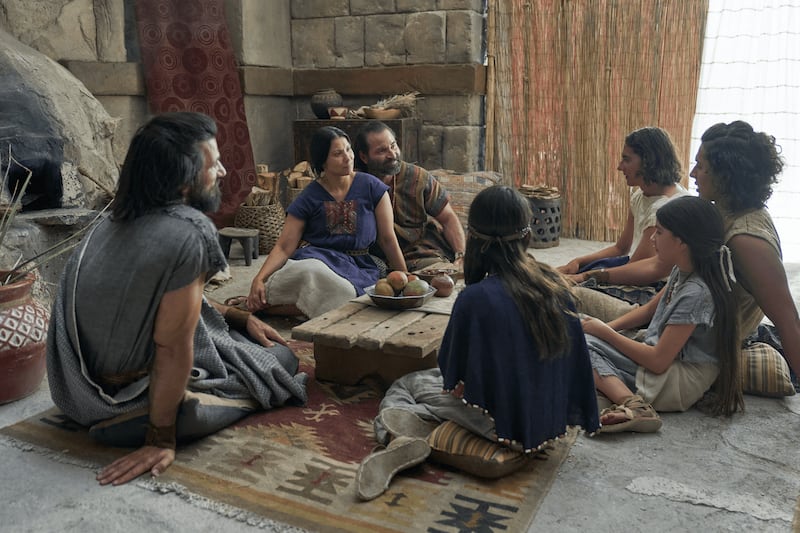 Alma the Younger, left, sits with Amulek and his family in this picture from the Book of Mormon Videos.