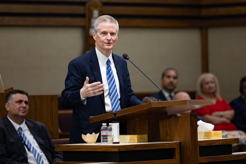 Elder David A. Bednar speaking from a pulpit in a stake meetinghouse.