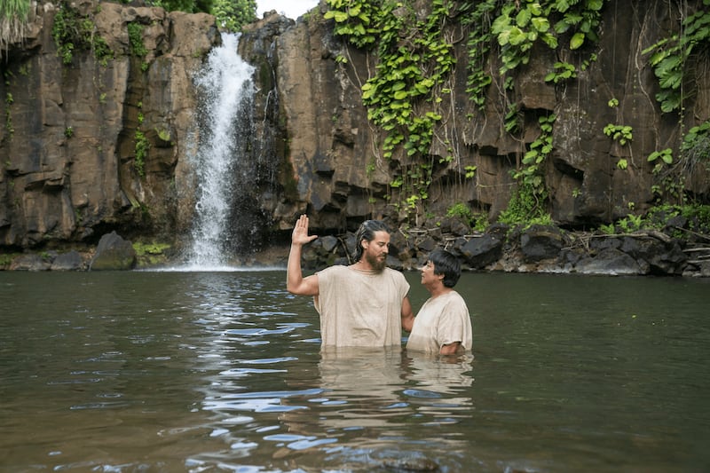 Alma baptizes a man at the waters of Mormon in this picture from the Book of Mormon videos.