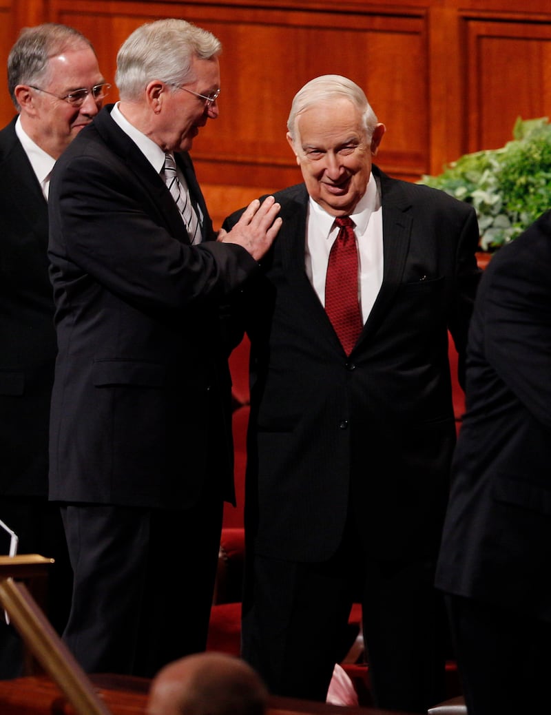 Elder D. Todd Christofferson visits with Elder Richard G. Scott.