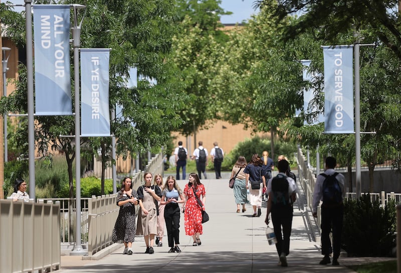 Missionaries walk on the campus of the Provo Missionary Training Center in Provo, Utah