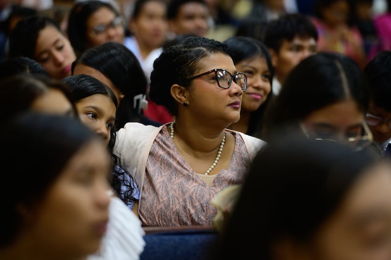 A woman in the audience listens during a devotional in Panama City, Panama.