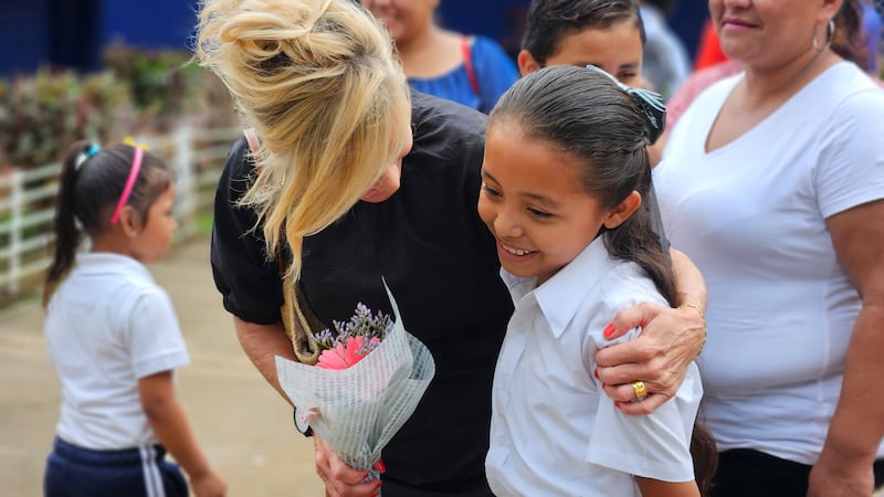 Sister Tamara W. Runia hugs a child at a school in rural Nicaragua