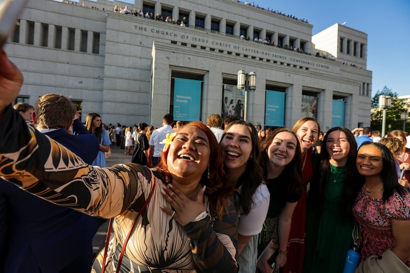 Attendees take selfies after the May 2022 worldwide devotional for young adults at the Conference Center.