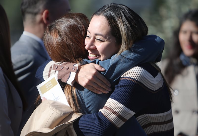 Two women hug after attending a temple dedication.