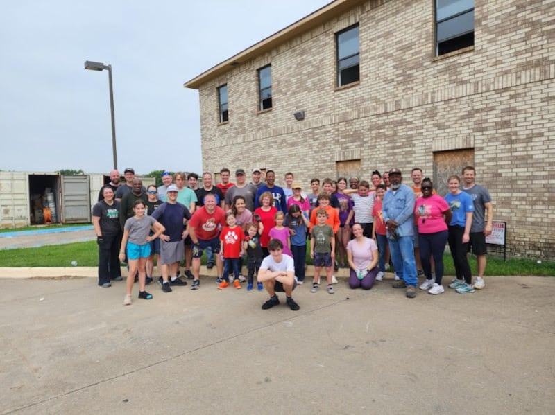 Members of The Church of Jesus Christ of Latter-day Saints and members of the Zion Baptist Church stand together after cleaning a vandalized building on May 25, 2024, in Rowlett, Texas.
