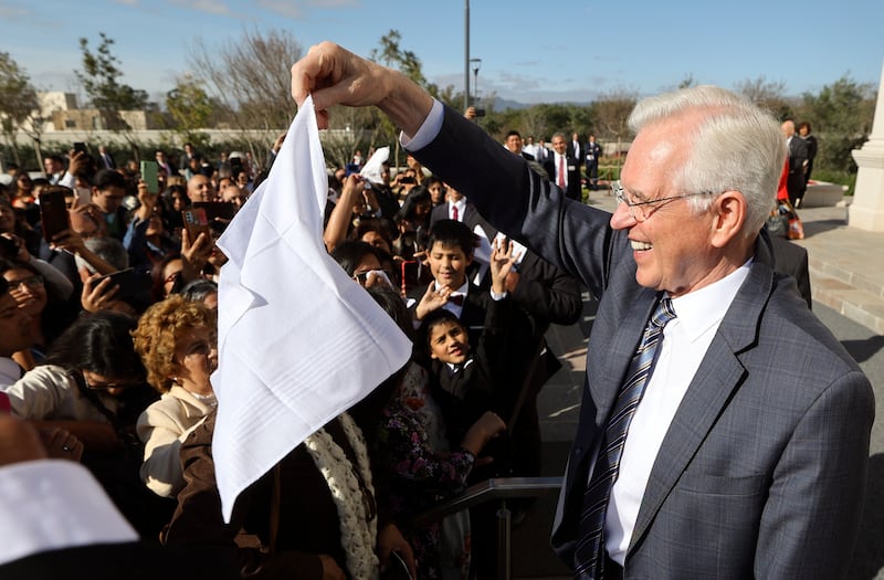 Elder Todd Christofferson waves a handkerchief after dedicating the Salta Argentina Temple.