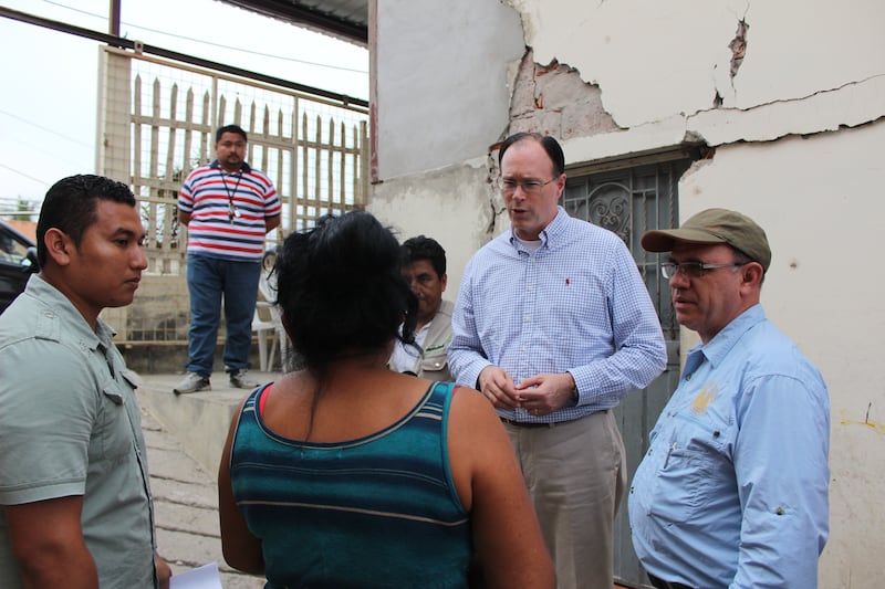 Bishop Christopher Waddell talking with citizens from Ecuador.