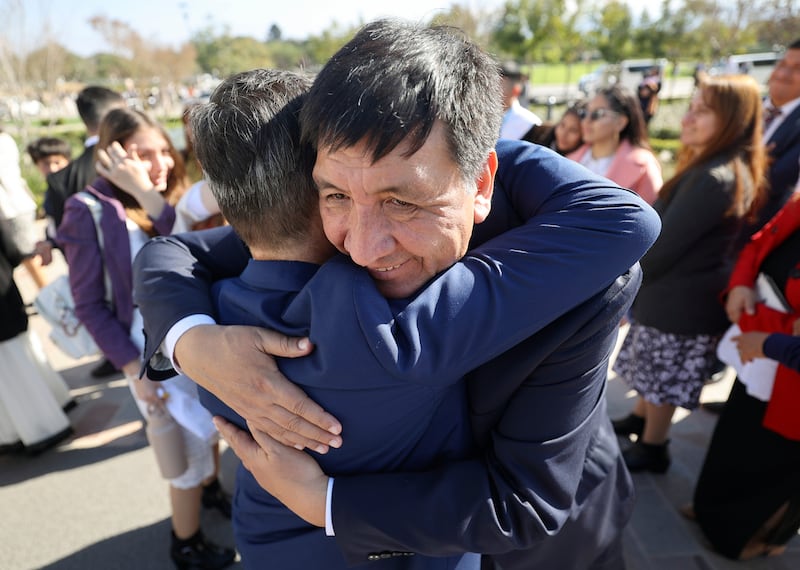 Men embrace after attending the dedication of the Salta Argentina Temple.