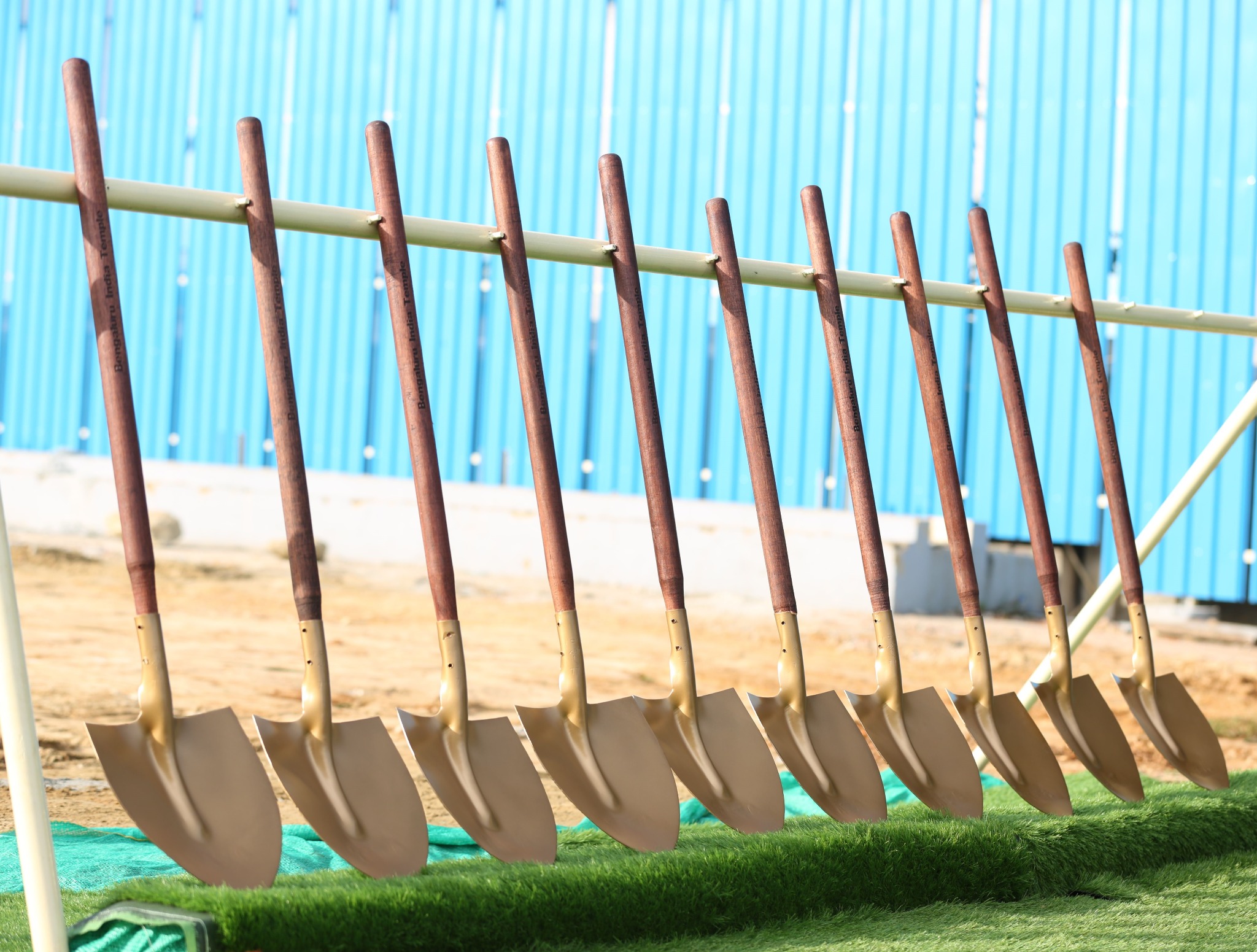 A row of ceremonial golden shovels standing up.