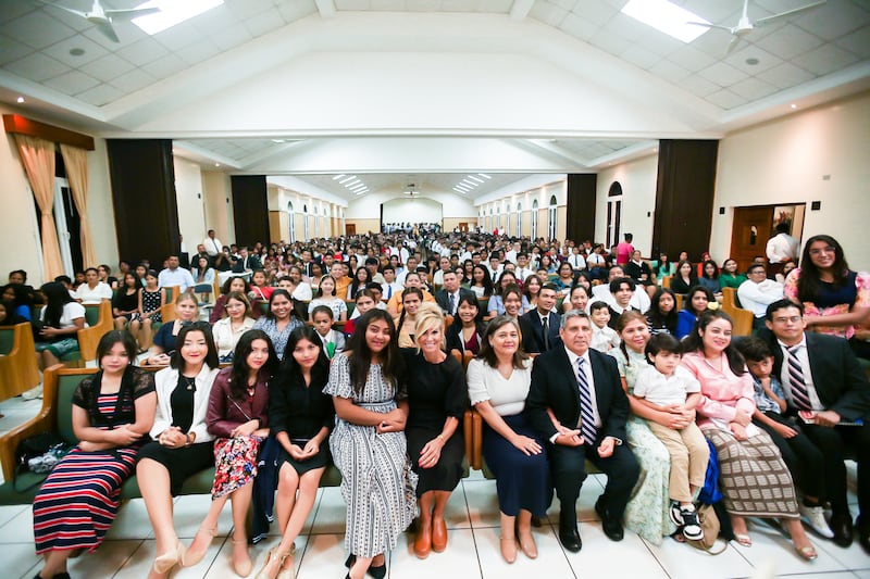 Sister Tamara W. Runia takes a photo with youth, their parents and leaders at a youth devotional in Managua, Nicaragua.