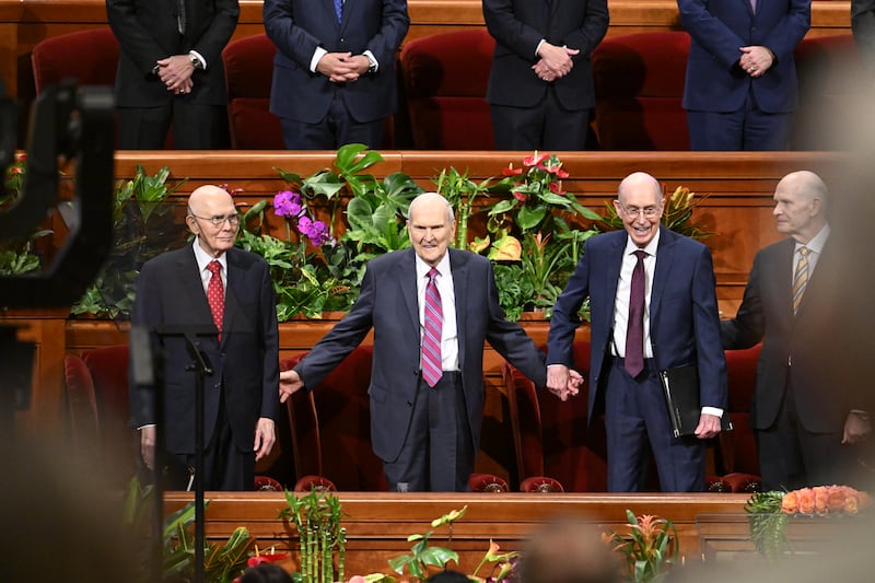 The First Presidency stands together in the Conference Center for the Saturday afternoon session of April 2024 general conference.