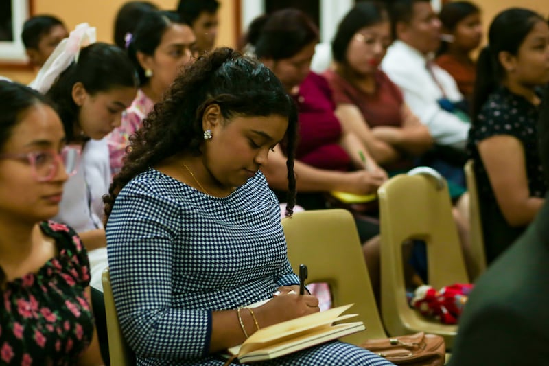 Note taking during a youth training meeting with Sister Tamara W. Runia, first counselor in the Young Women general presidency, in Managua, Nicaragua.